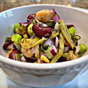 a bowl with beans, garbanzo or chickpea, green beans kidney beans onions and celery