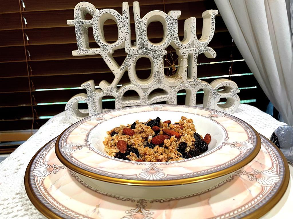 granola in a china bowl and the words follow your dream in front of it