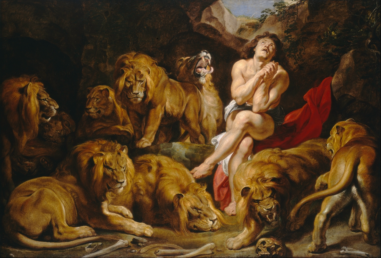 man scanty dressed in a den of lions