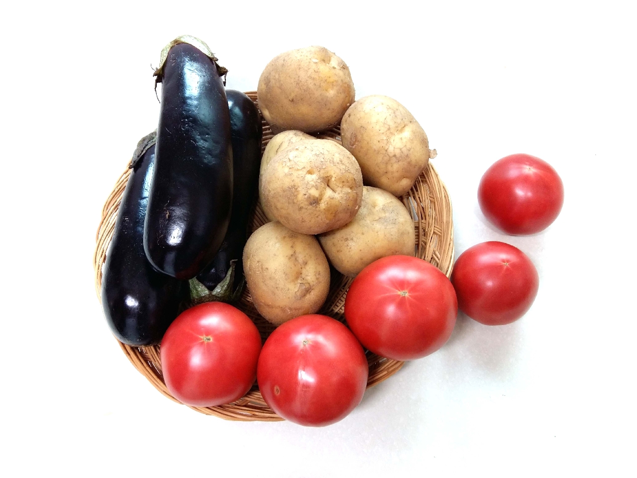 eggplant potato tomato in a basket