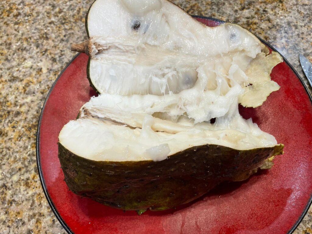 soursop cut in half on a red plate