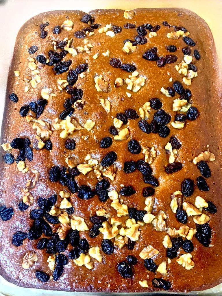 glass pan of ginger spice cake with raisins and nuts