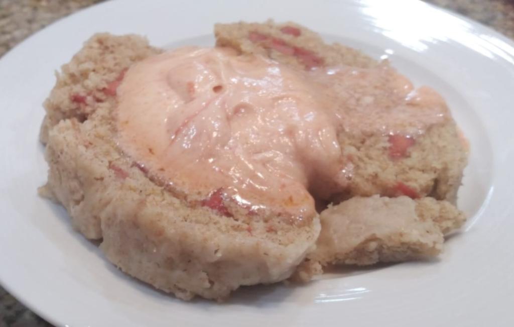 guava duff, 2 slices on a plate with sauce on top