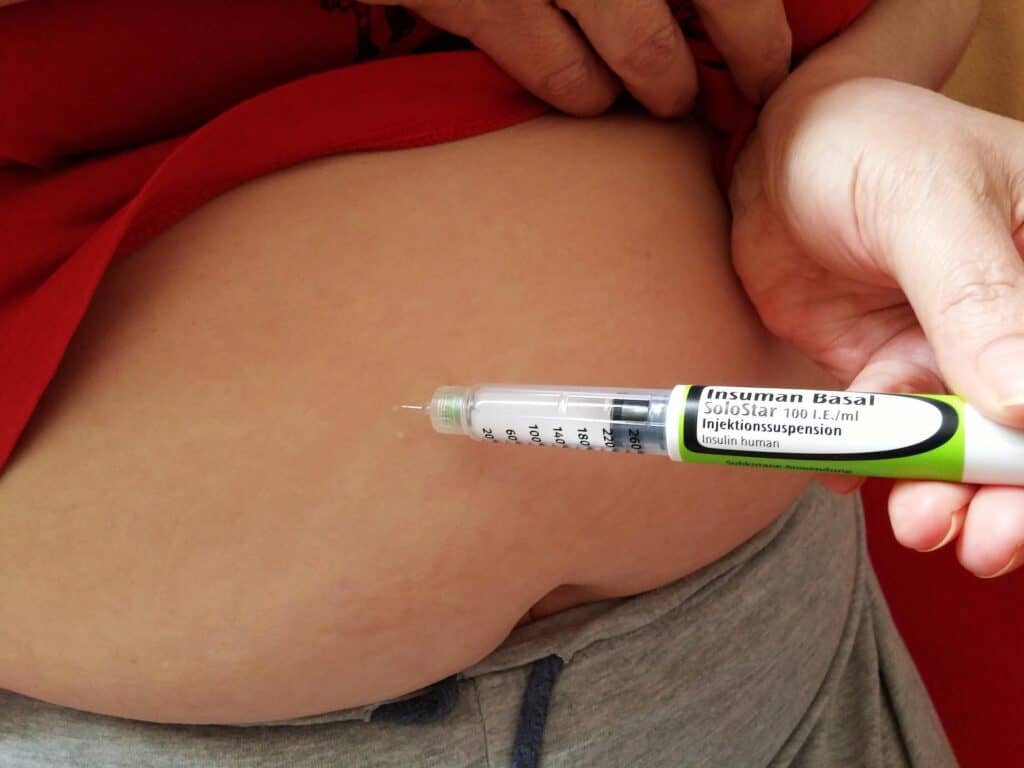a needle being injected in the stomach