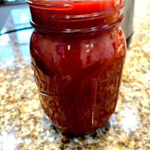 BBQ sauce in a balls jar on a counter