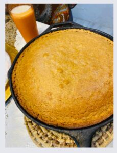 cornbread in a skillet with GLASS OF MILK
