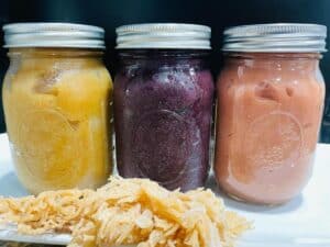 3 glass jars filled with blueberry, strawberry and peach flavoured sea moss
