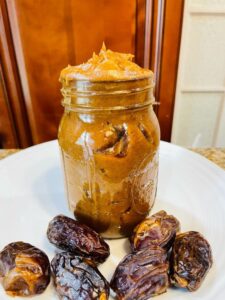 date spread and date paste recipe, dates on a plate with the date pureed in a balls jar with pineapple juice