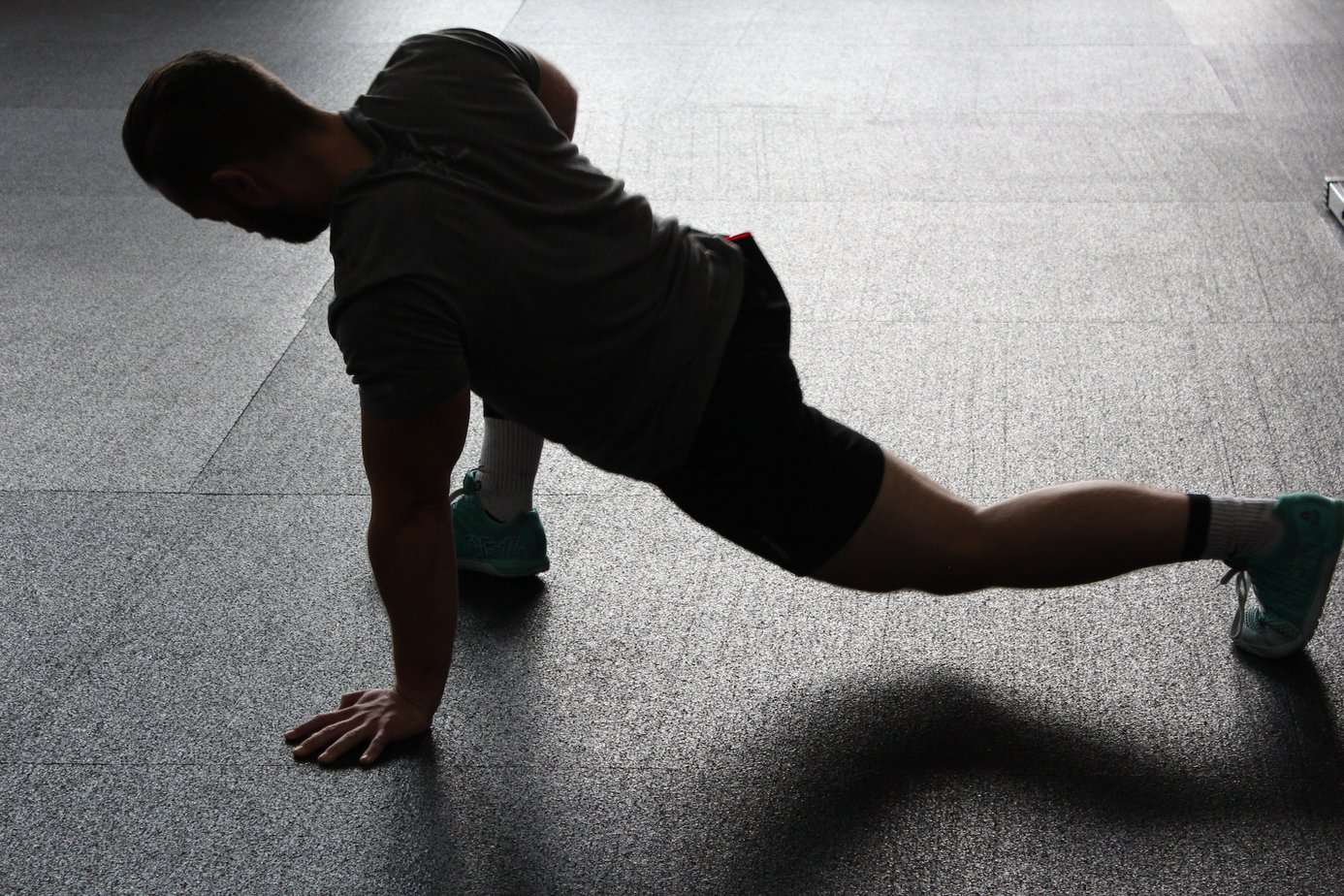 An athlete performing muscle stretching's exercise. 